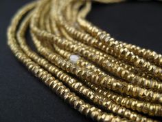 PRICES MAY VARY. Handmade by independent artisans in Ethiopia Each bead measures 1 x 2.5-3mm diameter, with hole size of 2mm Sold by the strand - wholesale value 100% Authentic Ethiopian product Official product of The Bead Chest Take a look at this great strand of Brass beads fashioned in a heishi shape. Each strand is 28" long with approximately 400 beads measuring 1 x 2.5-3mm diameter. These great beads are highly versatile and may be used as spacers or accents in your unique designs. A great Gold Multi-strand Gemstone Beads, Beads Types, Master Board, Brass Beads, Heishi Beads, Trade Beads, Brass Color, Ethiopia, Spacer Beads