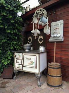 an old fashioned stove with pots and pans hanging from it