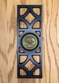 a metal object on top of a wooden floor with wood grained walls behind it