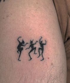 a man with a tattoo on his arm that has two people dancing in the air