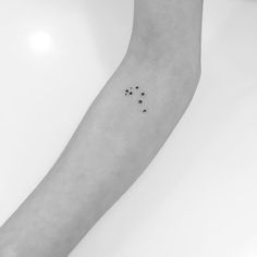 a person's arm with three dots on it and one dot in the middle