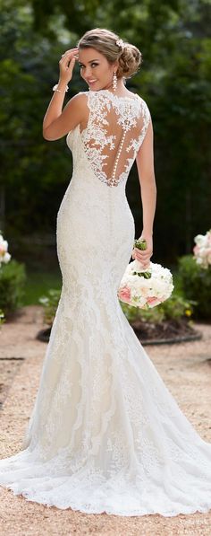 a woman in a wedding dress is posing for the camera