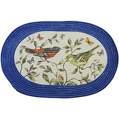 a blue oval rug with two birds on it