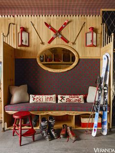 a room with skis and snowboards on the wall