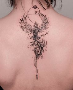 the back of a woman's neck with an angel and sun tattoo on it