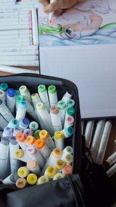 a black bag filled with lots of different colored markers