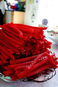 a bowl filled with red yarn sitting on top of a table