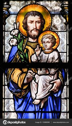 stained glass window depicting jesus holding the cross and child in his lap, with an ornate background