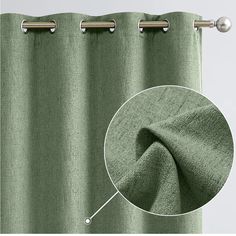 a close up view of a green curtain with metal rods and an image of the fabric