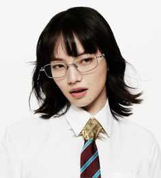 a young woman wearing glasses and a tie