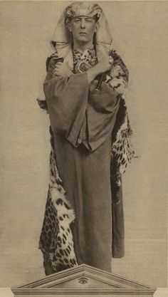 an old fashion photo of a woman dressed in leopard print clothing and headdress