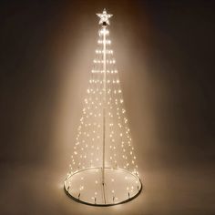 a lighted christmas tree in the middle of a room with lights on it and a star hanging from the top