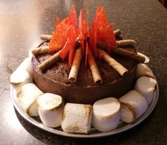 a chocolate cake with marshmallows and orange decorations