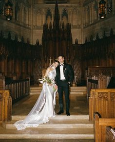 a bride and groom standing in front of the alter at a wedding ceremony with pews