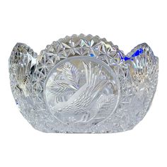 a clear glass bowl with a bird on the front and bottom, set against a white background