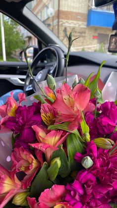 a bouquet of flowers in the passenger seat of a car