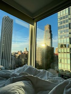 the sun is shining brightly through the windows in this cityscape view from a hotel room