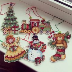 cross stitch christmas ornament kits displayed on table