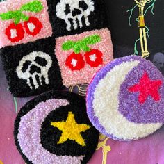 three crocheted patches with skulls and stars on them sitting next to each other