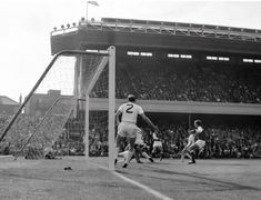 an old photo of a soccer game with the goalie getting ready to block the ball