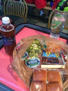 some food is sitting on a pink table