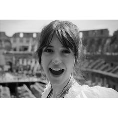 a black and white photo of a woman smiling