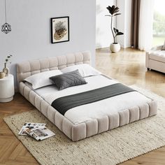 a large bed sitting on top of a wooden floor