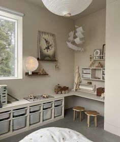 a child's playroom with toys and bookshelves on the wall, along with toy storage bins