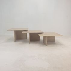 two tables sitting on top of each other in an empty room with no one around them