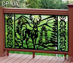 a metal gate with a deer on it in the middle of a wooden decking area