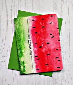 two watermelon notebooks sitting on top of each other, one is green and the other is red