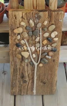 an image of a tree made out of wood and rocks on the side of a bench