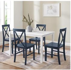 a dining room table with four chairs around it