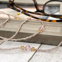 Sparkly eyeglass necklace chain made with Preciosa Czech crystal seed beads in golden tones with delicate multicolor flashes, featuring gold and pink cubic zirconia beads. Unique and bohemian this necklace chain will definitely create a unique look.   This eyeglass lanyard is made on strong quality beading wire with gold plated wire guardians that protect the quality eyeglass holder grips. The necklace is ended with spring clasps that hold the eyeglass grips and they can be easily removed to tra Gold Beaded Glasses Chains, Adjustable Beaded Glass Crystal Necklaces, Adjustable Glass Crystal Necklace With Beaded Chain, Gold Beaded Glasses Chains For Gift, Gold Glasses Chains With Colorful Glass Beads, Gold Glass Beaded Chain Necklaces, Gold Beaded Glass Necklace, Gold Glass Beaded Necklace, Adjustable Crystal Necklaces With Colorful Glass Beads