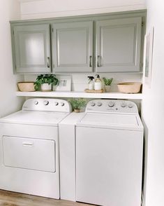 a white washer and dryer sitting in a kitchen next to eachother