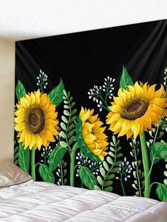 a sunflower tapestry hanging on the wall next to a bed