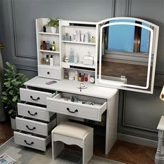 a white dressing table with drawers and a mirror