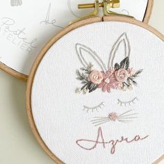 two embroidery hoops with flowers and bunny ears on them, one has the word agnes written in cursive writing