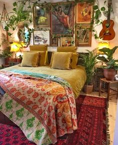 a bed with lots of plants and pictures on the wall