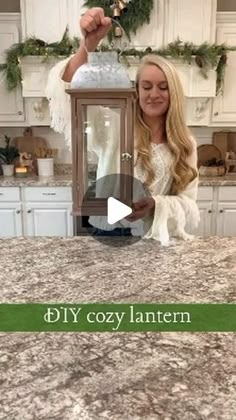 a woman is holding up a lantern in the kitchen