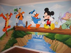 a mural of mickey mouse and other disney characters on a wooden bridge over a river