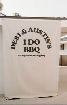 a white banner hanging from the side of a building that says dessi & austins, i do bbq