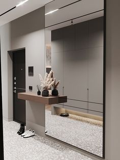 a large mirror in the middle of a room with shoes on the floor next to it