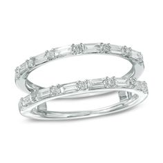 two white gold rings with baguetts and diamonds on each band, set in 18k white gold