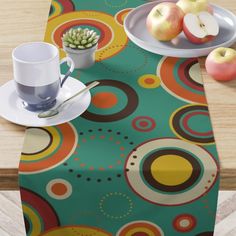 a table topped with plates and cups filled with fruit on top of a wooden table