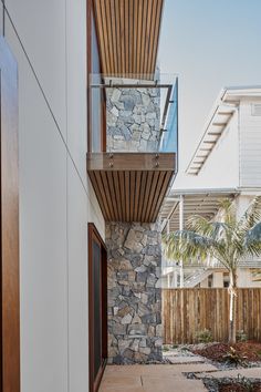 an outside view of a house with stone and wood