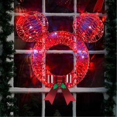 a lighted mickey mouse wreath on a window