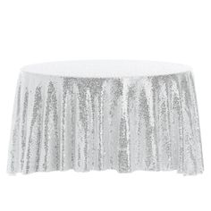 a white table cloth with silver sequins on the top and bottom, in front of a white background