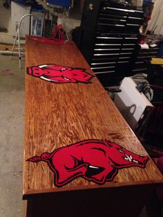 a long wooden table with the university of wisconsin logo on it in a garage area