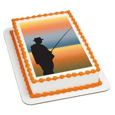 a birthday cake with an image of a man fishing on the lake and sunset in the background